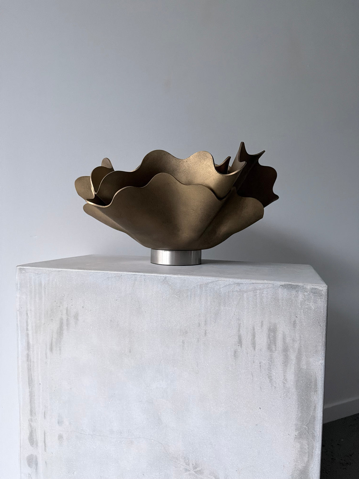 Aged Brass Peony Lamp, a sculptural lamp by Bec Stevens, on a concrete plinth