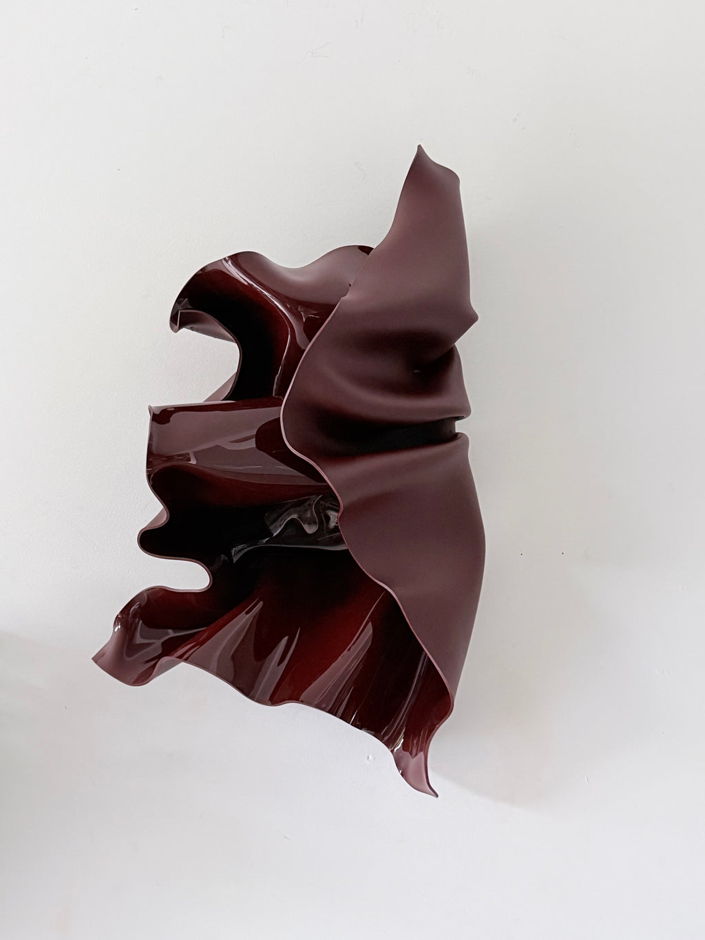 Deep Rosè, a wall sculpture by Bec Stevens in Chocolate Burgundy, on a white wall