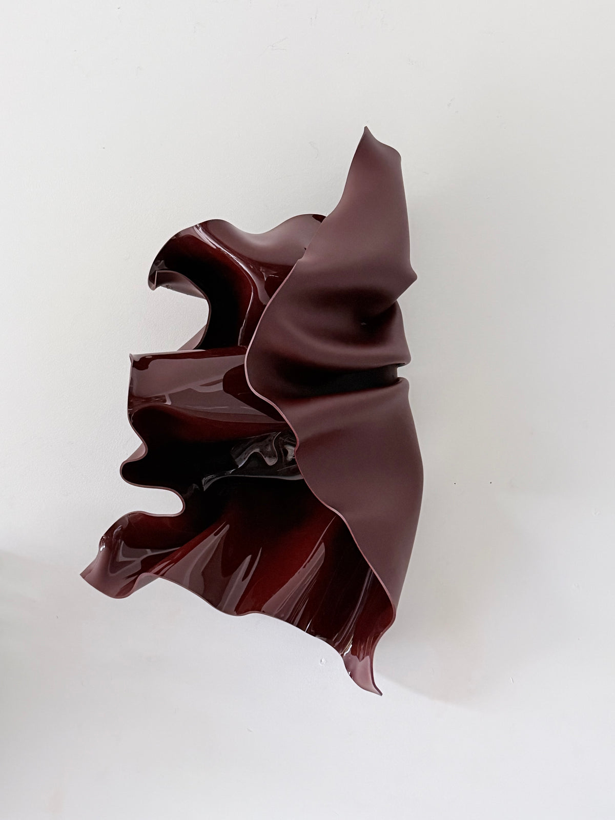 Deep Rosè, a wall sculpture by Bec Stevens in Chocolate Burgundy, on a white wall